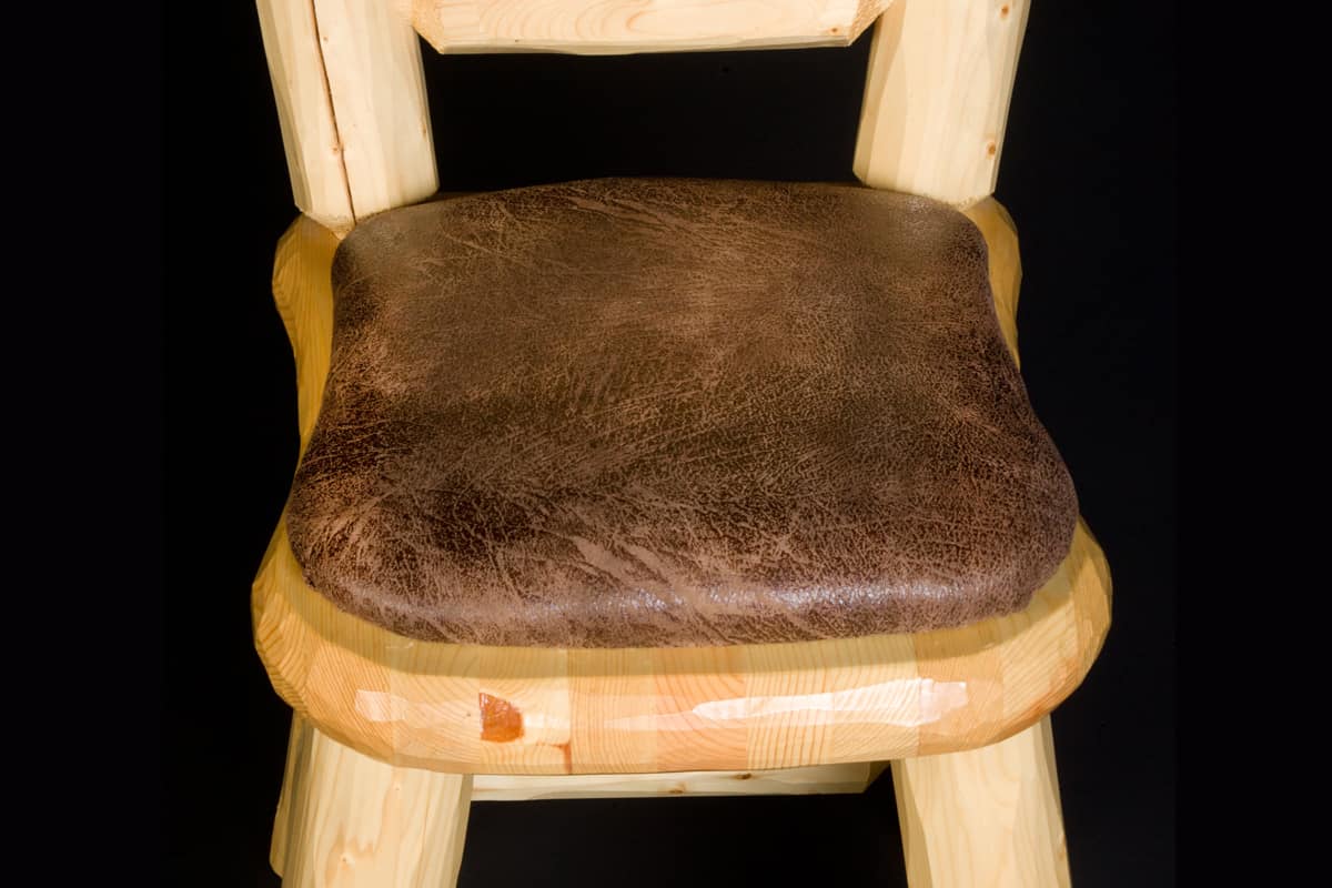 Detail of the upholstery in the Log Game Room/Dining Chair in Honey Pine Finish